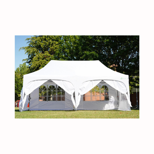 White gazebo set outdoors surrounded by trees under blue skies, by Thistle & Rose Events.