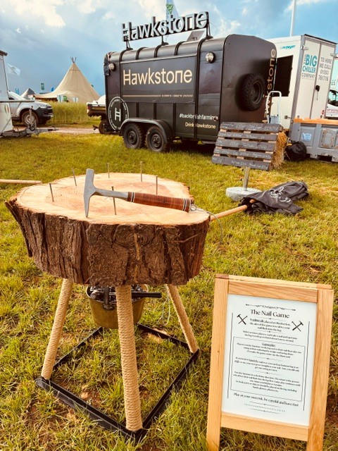 Close-up of Bucket and Ball garden game, showing metal buckets with wooden handles on a wooden platform, by Thistle & Rose Events.